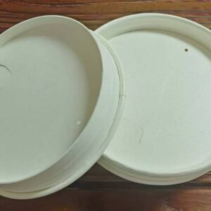 Two natural-colored paper cup lids displayed on a wooden surface.