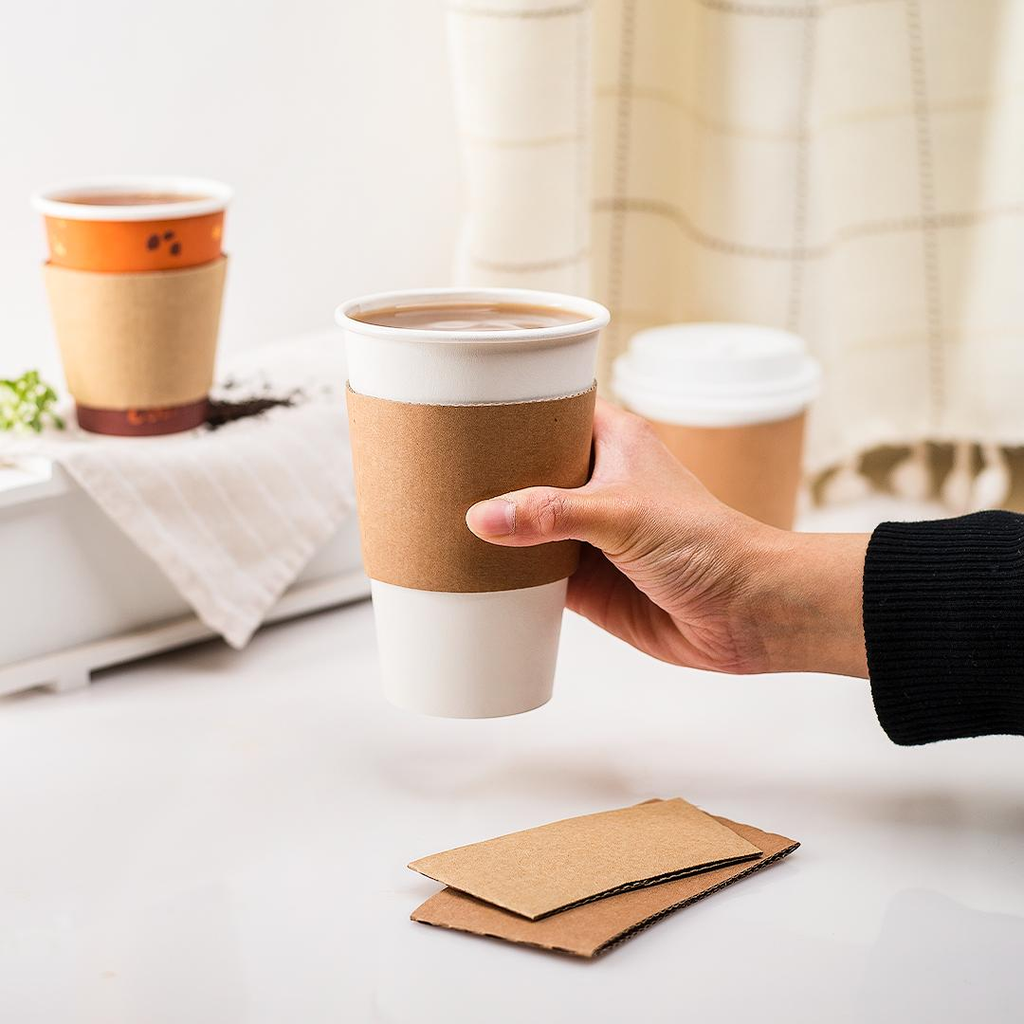 Custom printed kraft paper cup sleeves beside takeaway coffee cups